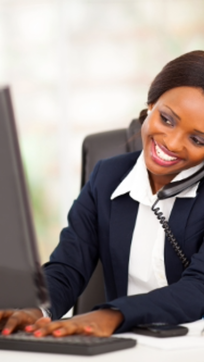 Woman on the Phone in front of Computer